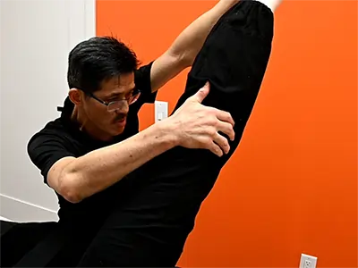 image of Kin Sze RMT providing leg stretching at b-Stretched Bay Adelaide Centre